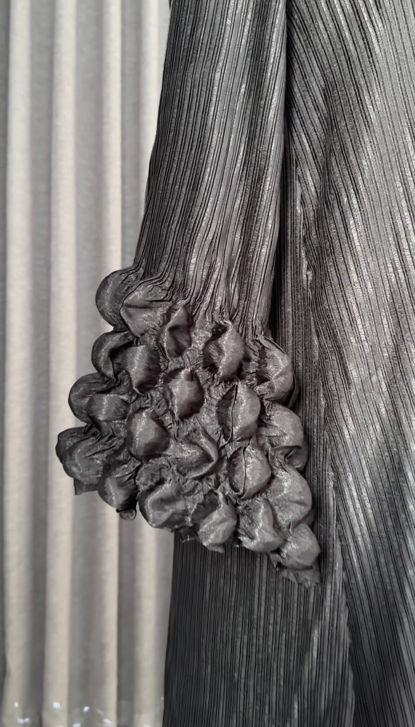 Black pleated dress with work in sleeves and bottom