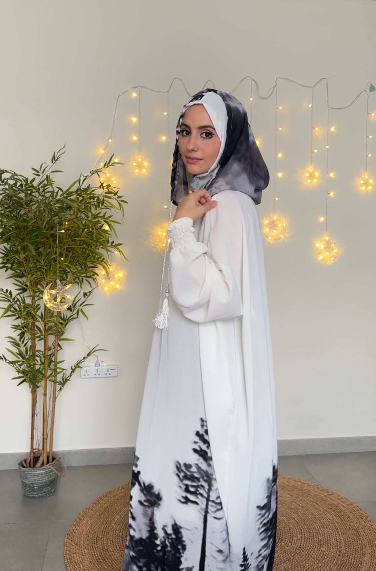 White burqa with black tree pattern at the bottom