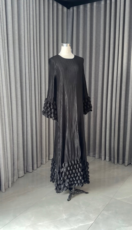 Black pleated dress with work in sleeves and bottom