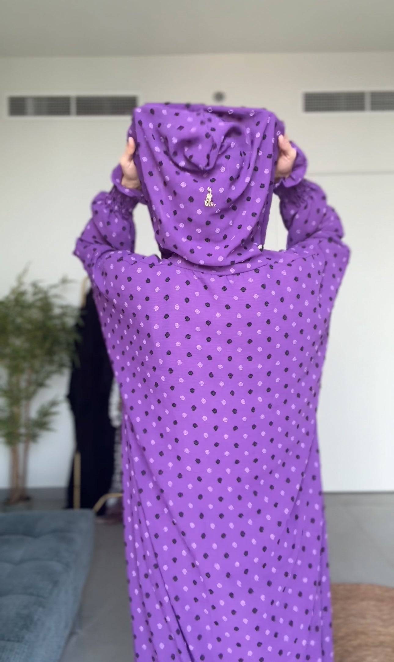 Bright purple burqa with black dots