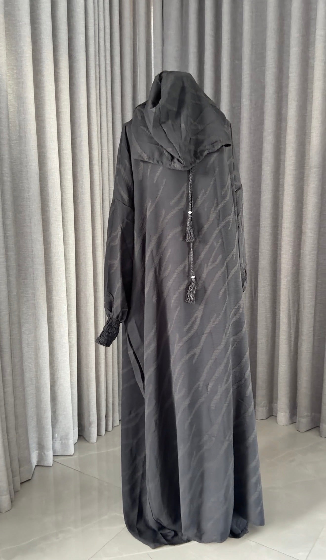 Black burqa with wavy lines