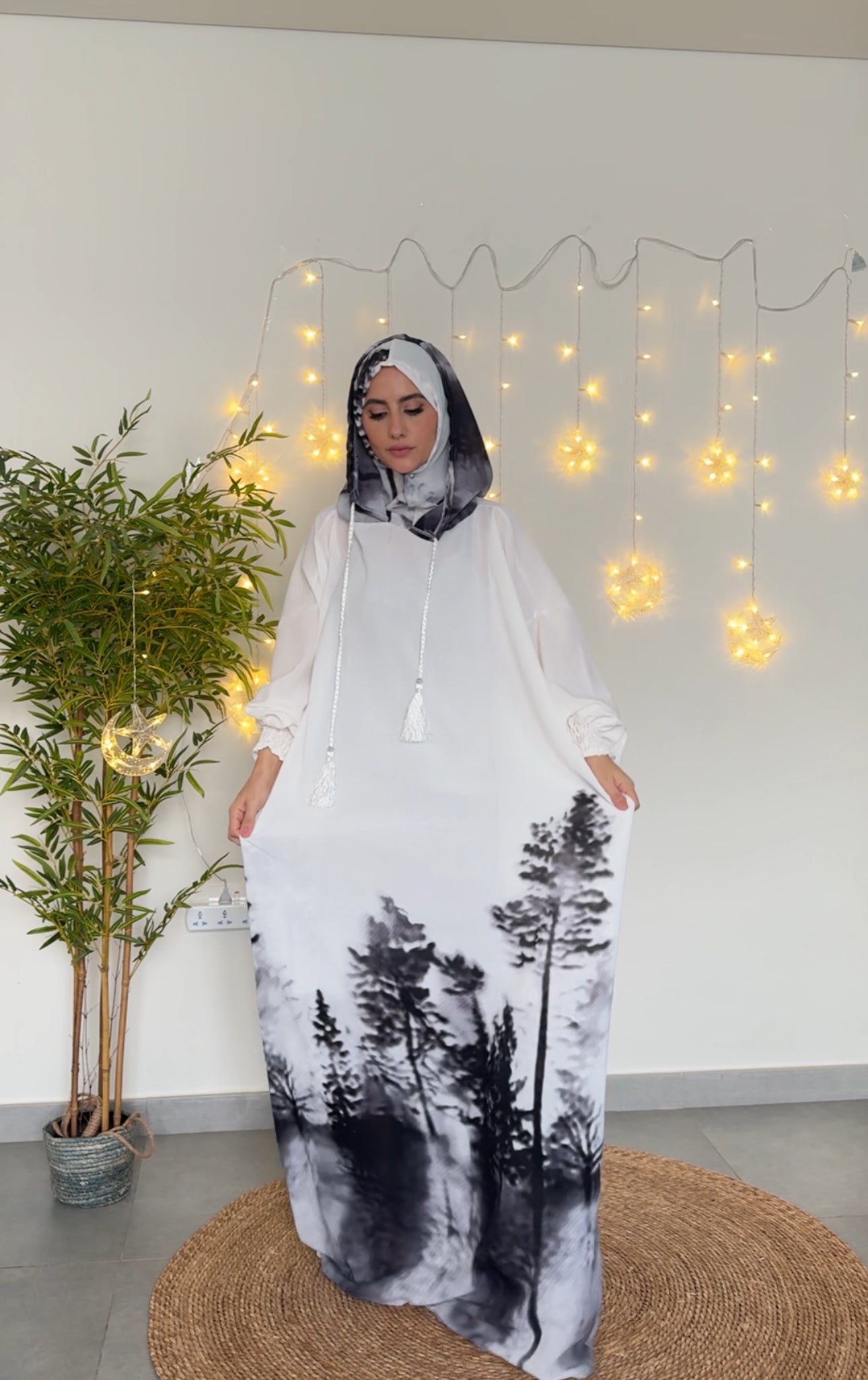 White burqa with black tree pattern at the bottom