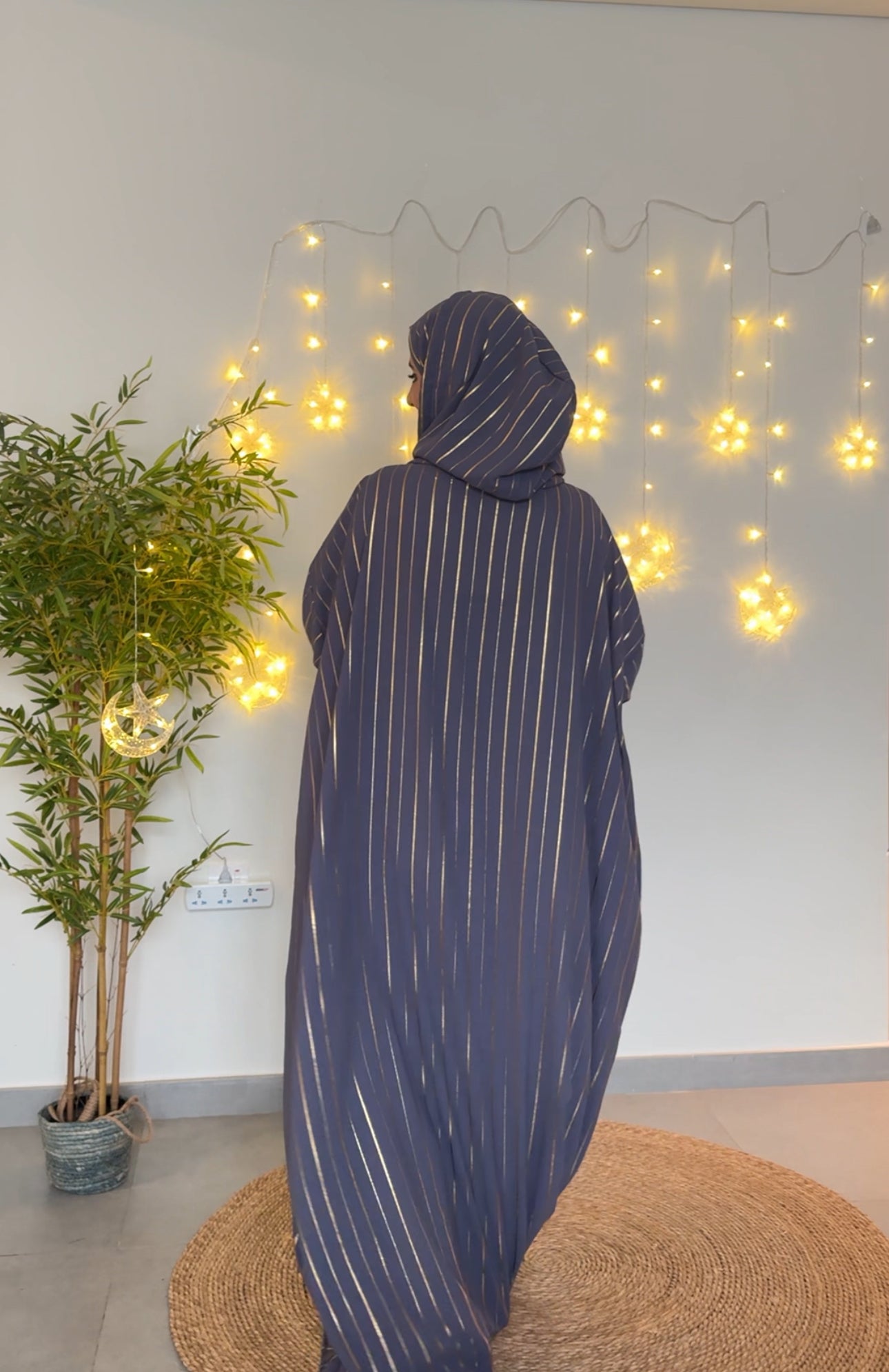 Dark gray burqa with thin gold vertical lines