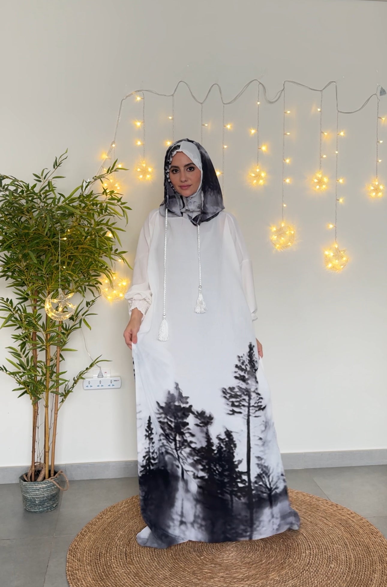 White burqa with black tree pattern at the bottom