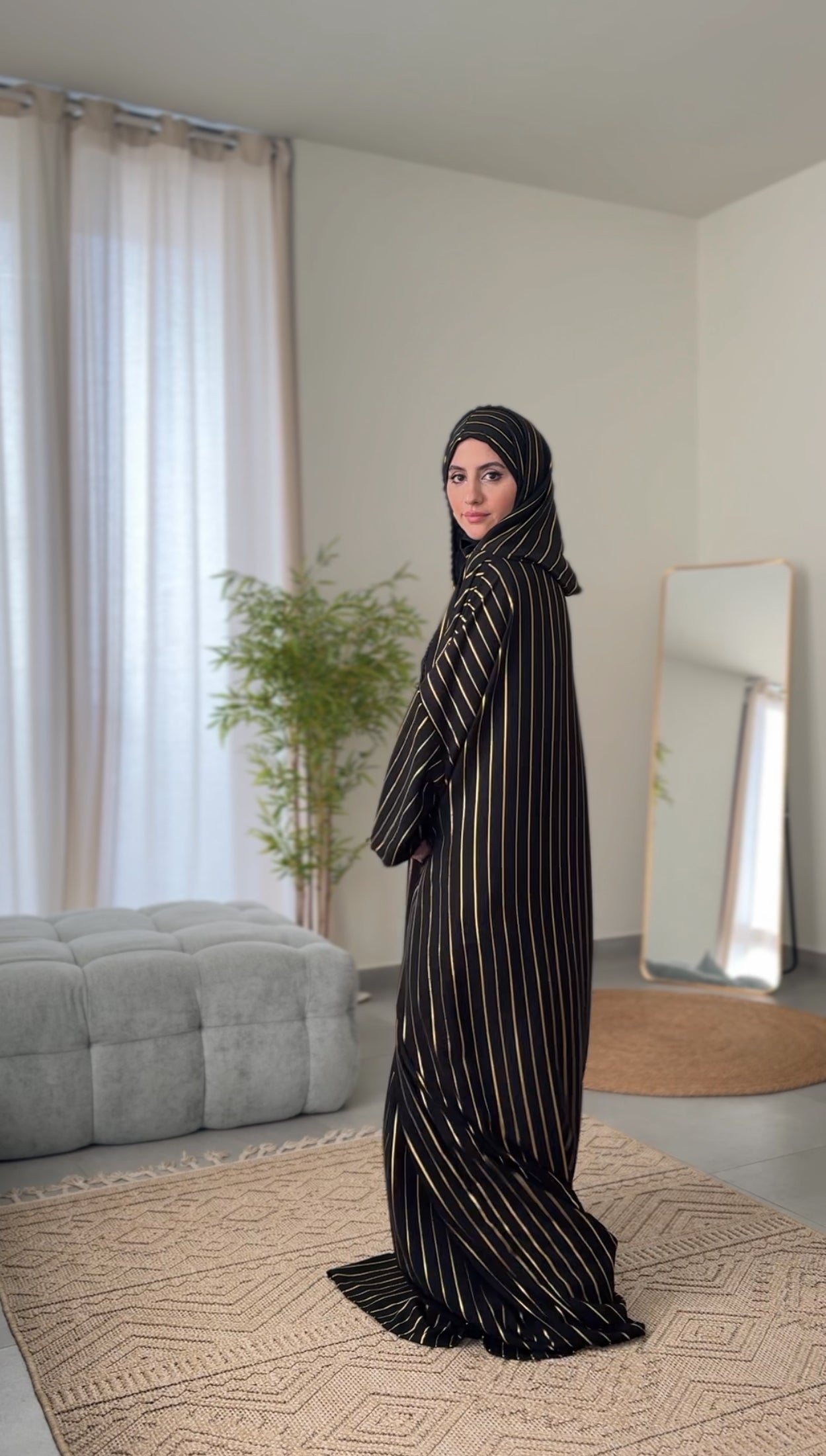 Black burqa with thin gold vertical lines